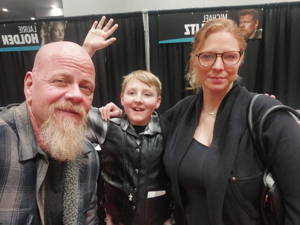 Kendrah Wong, far right, said her son Kache Grist was a big fan of the comic and TV show The Walking Dead. Grist and his mother posed for a photo with actor Abraham Ford at Edmonton Fan Expo.