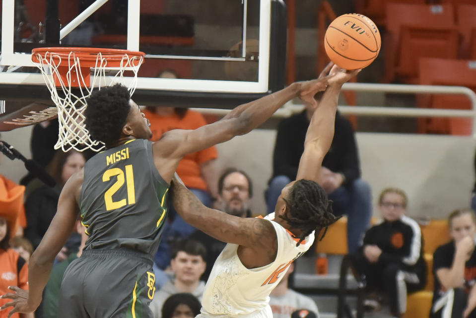 Baylor center Yves Missi, left, blocks a shot by Oklahoma State guard Javon Small, right, during the first half of an NCAA college basketball game, Saturday, Jan. 6, 2024, in Stillwater, Okla. (AP Photo/Kyle Phillips)