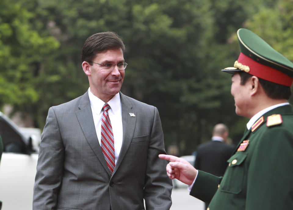 U.S. Defense Secretary Mark Esper, left, and Vietnamese Defense Minister Ngo Xuan Lich talk before a meeting in Hanoi, Vietnam Wednesday, Nov. 20, 2019. Esper is on a visit to Vietnam to strengthen the military relations with the Southeast Asian nation. (AP Photo/Hau Dinh)