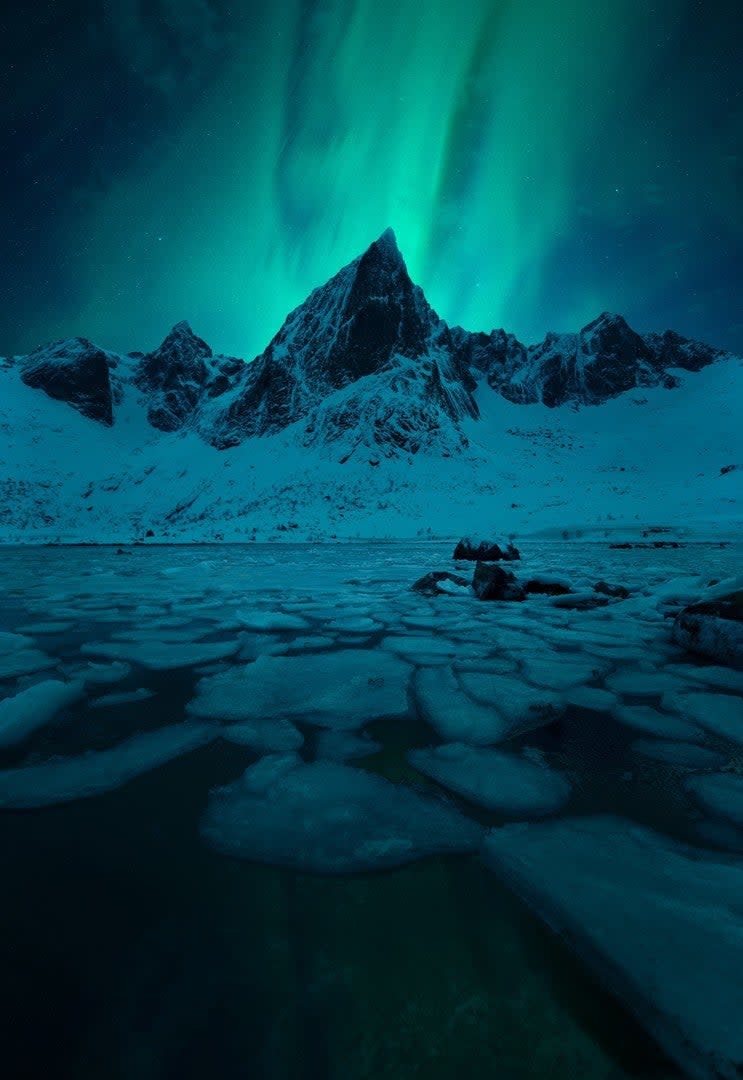 The Northern Lights over the Lofoten Island peaks.