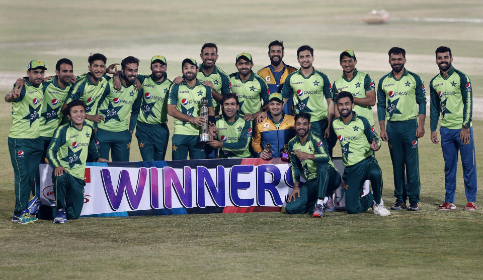 The Pakistani cricket team poses with the winners trophy of the Twenty20 series at a ceremony after the 3rd Twenty20 cricket match against Zimbabwe at the Pindi Cricket Stadium, in Rawalpindi, Pakistan, Tuesday, Nov. 10, 2020. Pakistan won the series 3-0. (AP Photo/Anjum Naveed)