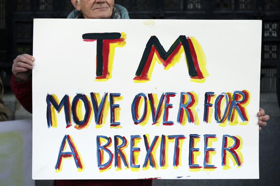 Pro-Brexit demonstrators who oppose Theresa May hold placards outside the Houses of Parliament. (AP Photo/Tim Ireland)