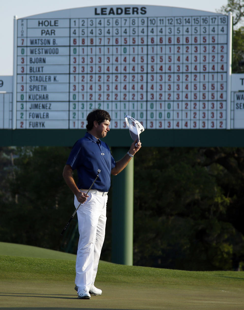 Bubba Watson tips his cap after putting on the 18th green during the third round of the Masters golf tournament Saturday, April 12, 2014, in Augusta, Ga. (AP Photo/Matt Slocum)