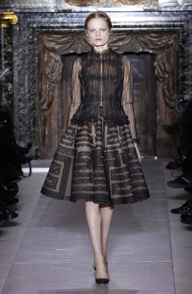 <b>Valentino SS13 <br></b><br>This gothic-style gown featured a high neck and maze print, which Valentino teamed with matching black heels.<br><br>© Rex