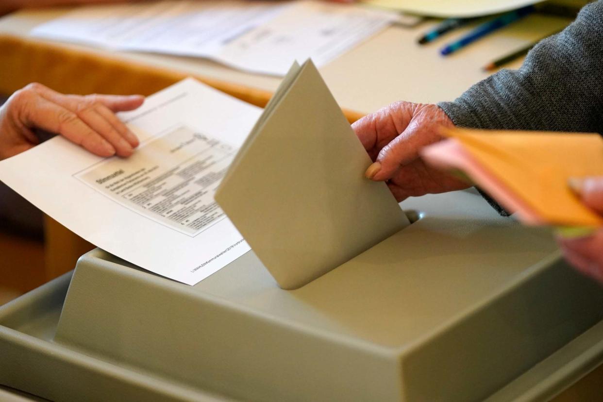 A voter casts their vote in the elections: EPA