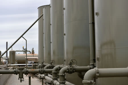 Storage tanks are seen at a production facility owned by Exxon near Carlsbad, New Mexico, U.S. February 11, 2019. Picture taken February 11, 2019. To match Insight USA-SHALE/MAJORS REUTERS/Nick Oxford