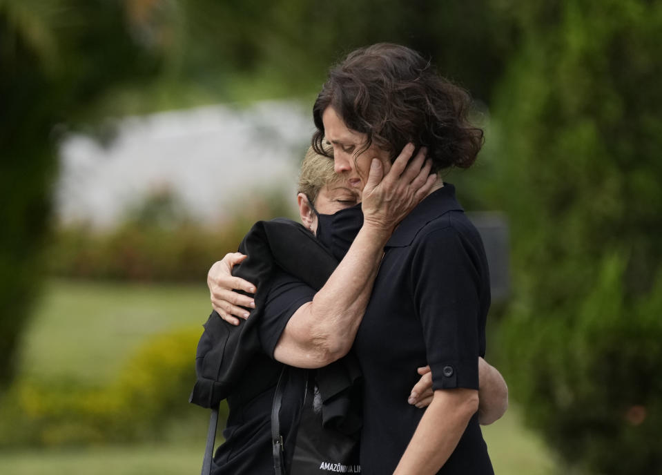 Alessandra Sampaio, right, is comforted during the funeral of her husband British journalist Dom Phillips at the Parque da Colina cemetery in Niteroi, Brazil, Sunday, June 26, 2022. Family and friends paid their final respects to Phillips who was killed in the Amazon region along with the Indigenous expert Bruno Pereira. (AP Photo/Silvia Izquierdo)