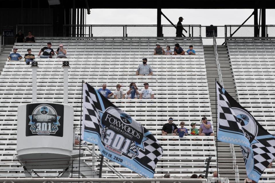 Fans sit socially distanced due to the coronavirus pandemic in the grandstand before a NASCAR Cup Series auto race, Sunday, Aug. 2, 2020, at the New Hampshire Motor Speedway in Loudon, N.H. (AP Photo/Charles Krupa)