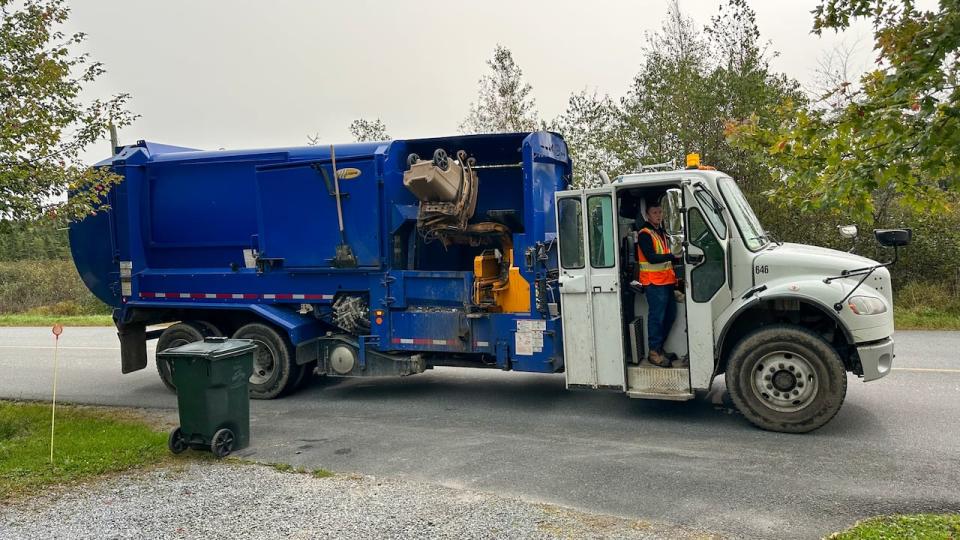 A Saint John garbage truck empties a homeowner's bin on Golden Grove Road on Wednesday.