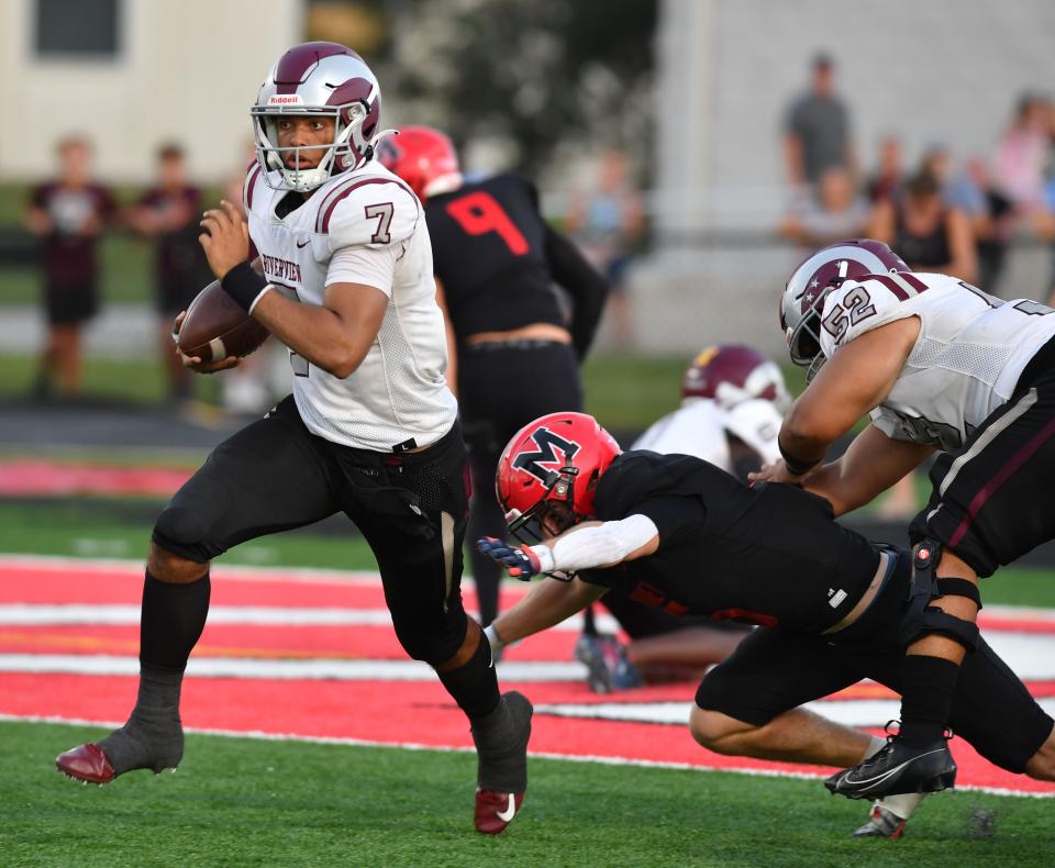 Riverview quarterback Braxton Thomas (#7) keeps the ball and looks for a hole in the Mooney defense. The Cardinal Mooney Cougars hosted the Riverview Rams Thursday evening, Sept. 14, 2023.