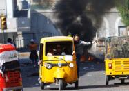 Demonstrators use tuk-tuk during the ongoing anti-government protests in Baghdad