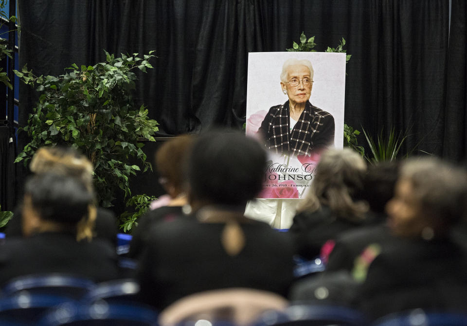 A portrait of NASA mathematician Katherine Johnson faces guests prior to a memorial service in her honor on Saturday, March 7, 2020, at Hampton University Convocation Center in Hampton, Va. Johnson, a mathematician who calculated rocket trajectories and earth orbits for NASA’s early space missions and was later portrayed in the 2016 hit film “Hidden Figures,” about pioneering black female aerospace workers died on Monday, Feb. 24, 2020. She was 101. (Kaitlin McKeown /The Virginian-Pilot via AP)