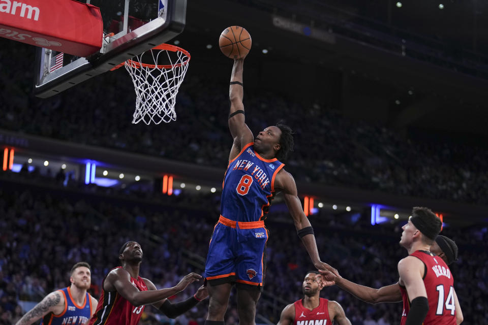 NEW YORK, NEW YORK - JANUARY 27: OG Anunoby #8 of the New York Knicks dunks the ball past Bam Adebayo #13, Jimmy Butler #22, and Tyler Herro #14 of the Miami Heat at Madison Square Garden on January 27, 2024 in New York City. NOTE TO USER: User expressly acknowledges and agrees that, by downloading and or using this photograph, User is consenting to the terms and conditions of the Getty Images License Agreement. (Photo by Mitchell Leff/Getty Images)