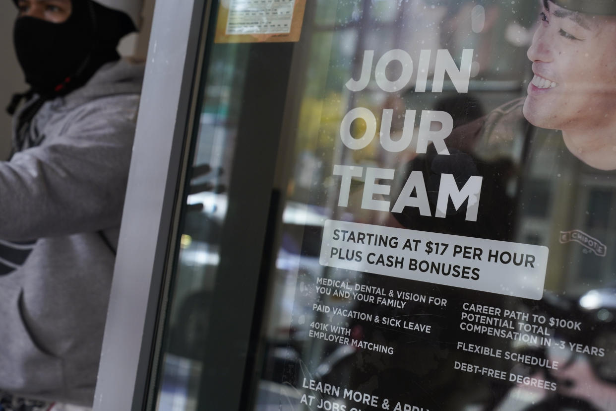 A hiring sign hangs in the window of a Chipotle in New York, Tuesday, Nov. 1, 2022. Starting this week, job-seekers in New York City will have access to a key piece of information: how much money they can expect to earn for an advertised opening. New York will require employers as of Nov. 1 to disclose 