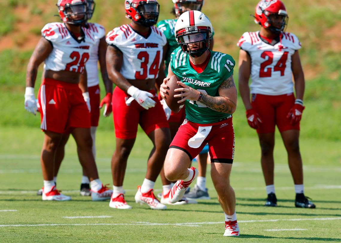 N.C. State quarterback Devin Leary (13) runs drills during the Wolfpack’s first practice of fall camp in Raleigh, N.C., Wednesday, August 3, 2022.