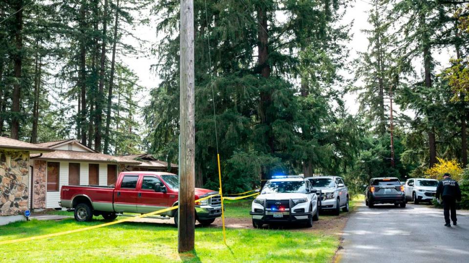 Law enforcement personnel from the Pierce County Sheriff’s Department wait to begin investigating the scene of a homicide on the 16000 block 50th Ave Court East in Tacoma, Wash. on Tuesday, April 12, 2022.
