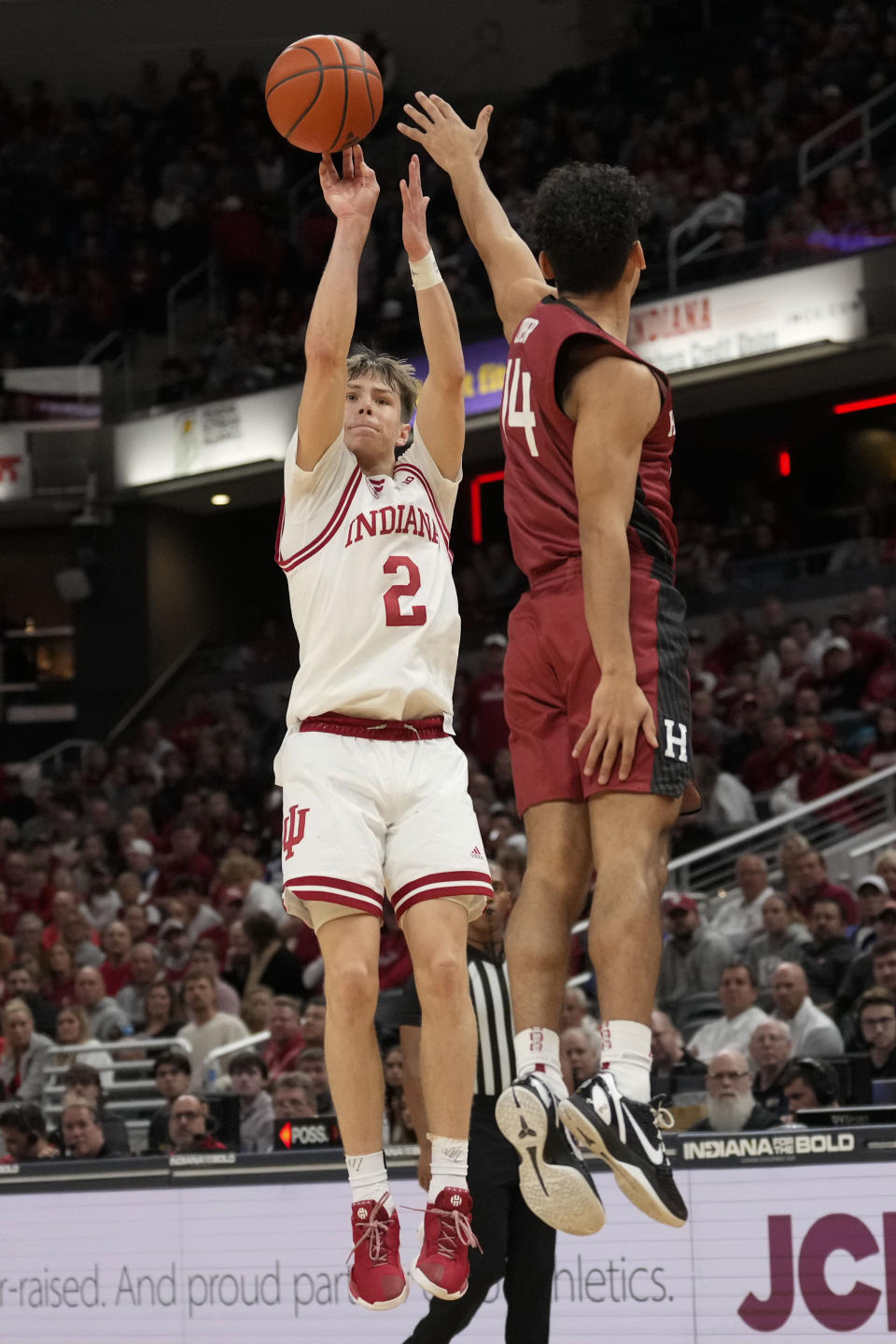 Indiana guard Gabe Cupps (2) shoots over Harvard guard Greg Cooper (14) in the second half of an NCAA college basketball game in Indianapolis, Sunday, Nov. 26, 2023. (AP Photo/AJ Mast)