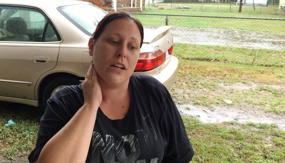 In this Sept. 15, 2018 photo, Jackie Washington discusses plans to evacuate ahead of flooding at her home in Lumberton, N.C., in the aftermath of Hurricane Florence. Jackie and Quinton Washington lost their home in Lumberton to flooding during Matthew. They finished rebuilding last October. Then on Friday the couple and their two children evacuated again as the Lumber River began overflowing. (AP Photo/Jonathan Drew)