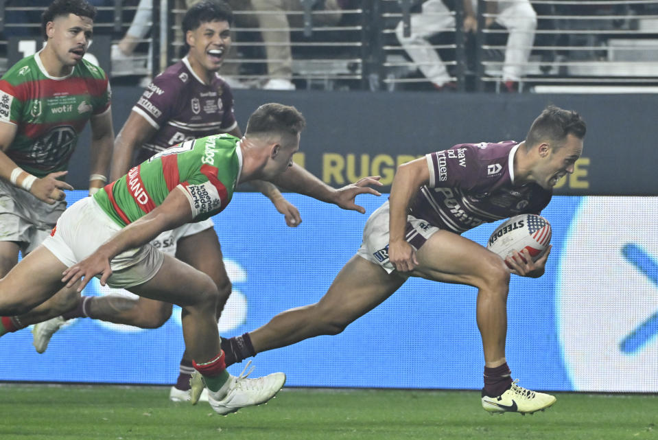 Sea Eagles Luke Brooks, right, runs in to score a try during the opening match of the NRL between the Manly Warringah Sea Eagles and the South Sydney Rabbitohs at Allegiant Stadium in Las Vegas, Saturday, March 2, 2024. (AP Photo/David Becker)