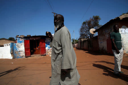 People are seen moving across the street in Banjul, Gambia April 7, 2017. REUTERS/Luc Gnago