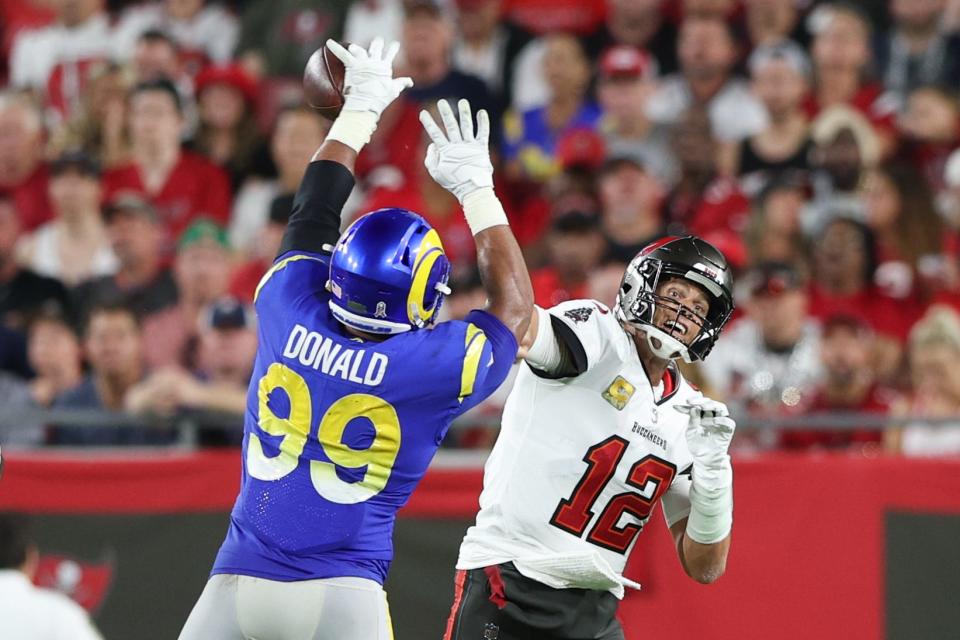 Los Angeles Rams defensive tackle Aaron Donald (99) breaks up a pass by Tampa Bay Buccaneers quarterback Tom Brady.