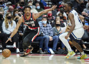 Portland Trail Blazers guard Dennis Smith Jr., left, dribbles past Minnesota Timberwolves guard Jaylen Nowell during the first half of an NBA basketball game in Portland, Ore., Tuesday, Jan. 25, 2022. (AP Photo/Craig Mitchelldyer)