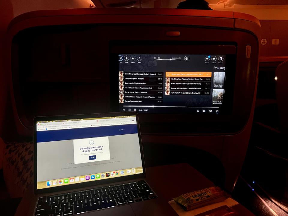 The TV with my laptop in front of it on the tray table.