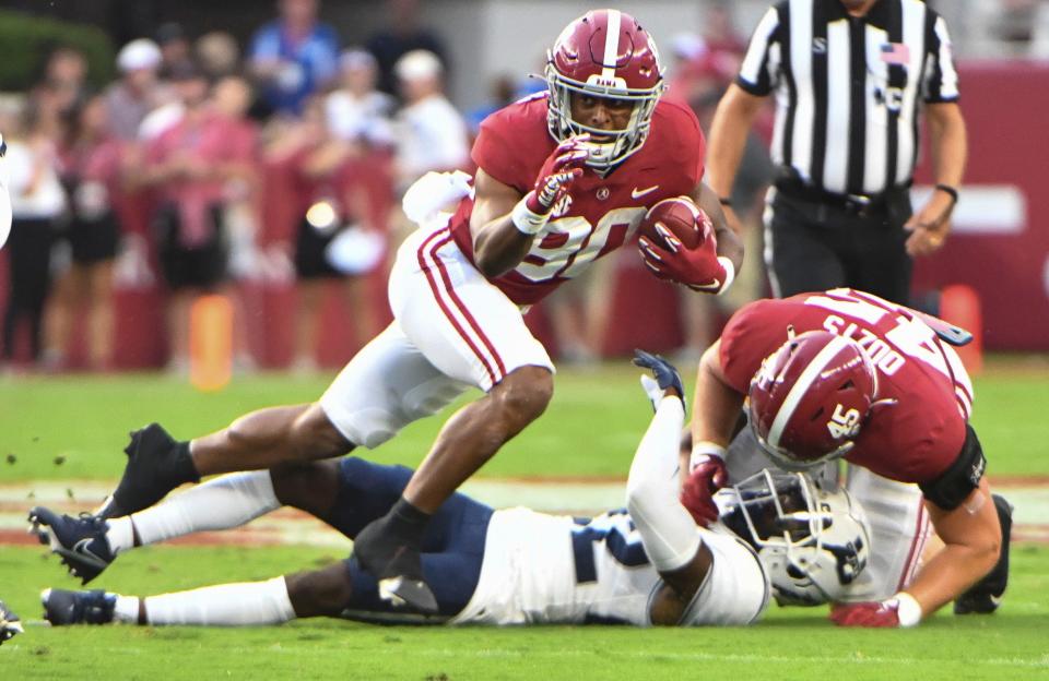 Alabama wide receiver Kobe Prentice (80) runs the ball after catching a pass against Utah State during the first half at Bryant-Denny Stadium.