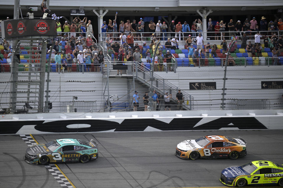 Austin Dillon (3) crosses the finish line in front of Tyler Reddick (8) and Austin Cindric (2) to win a NASCAR Cup Series auto race at Daytona International Speedway, Sunday, Aug. 28, 2022, in Daytona Beach, Fla. (AP Photo/Phelan M. Ebenhack)