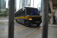 A prison van arrives as journalists wait for Tong Ying-kit's arrival at the Hong Kong High Court in Hong Kong Friday, July 30, 2021. Tong was convicted Tuesday of inciting secession and terrorism for driving his motorcycle into a group of police officers during a July 1, 2020, pro-democracy rally while carrying a flag bearing the banned slogan, "Liberate Hong Kong, revolution of our times." Tong, 24, will be sentenced Friday, the court announced. (AP Photo/Vincent Yu)