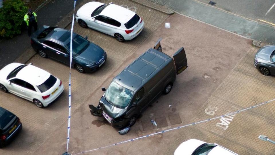 Police tape around a van on Laing Close in Hainault, east London following reported stabbings and attacks on police officers. A sword-wielding man has been arrested after witnesses spoke of shrieks and screams following reported stabbings and attacks