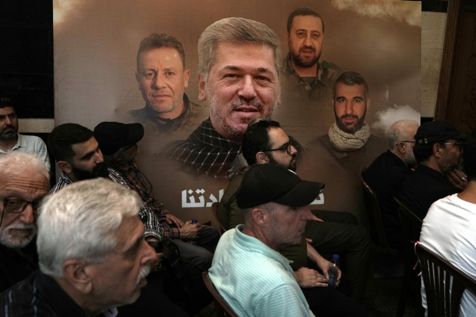 Hezbollah supporters watch a speech given by Hezbollah leader Sayyed Hassan Nasrallah on a screen during a ceremony to commemorate the death of senior Hezbollah commander Taleb Sami Abdullah, in the southern Beirut suburb of Dahiyeh, Lebanon, Wednesday, June 19, 2024. Abdullah was killed last week by an Israeli strike in south Lebanon. The poster, background, shows Abdullah and three Hezbolllah militants who were killed in the strike. (AP Photo/Bilal Hussein)