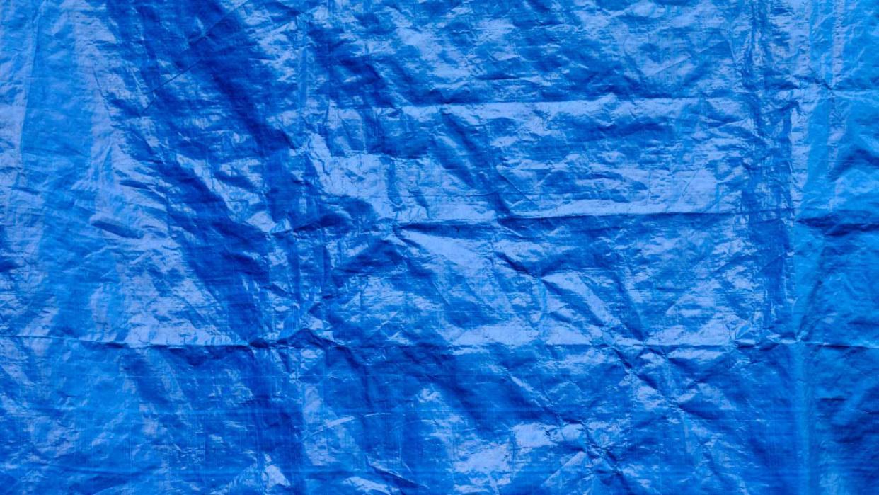 Close up of a blue crumpled canvas cover