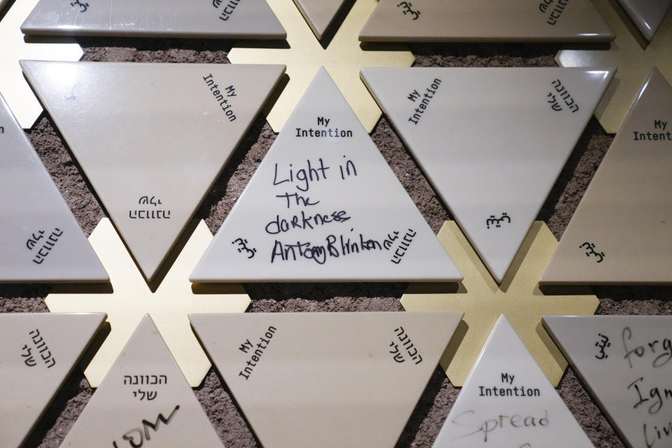 FILE - A tile signed by Secretary of State Antony Blinken is displayed on the intention wall at the Abrahamic Family House, in Abu Dhabi, United Arab Emirates, Oct. 14, 2023. Blinken wrote "Light in the darkness" on the tile before placing it on the wall. AP Washington photographer Jacquelyn Martin recalls how being one of a few female photographers covering news and politics was useful when she was assigned as the press pooler for Blinken's last-minute trip to Israel and the Middle East in the aftermath of the Hamas attacks. Martin said, “Sometimes people not knowing what to make of you works in your favor.” (AP Photo/Jacquelyn Martin, Pool, File)