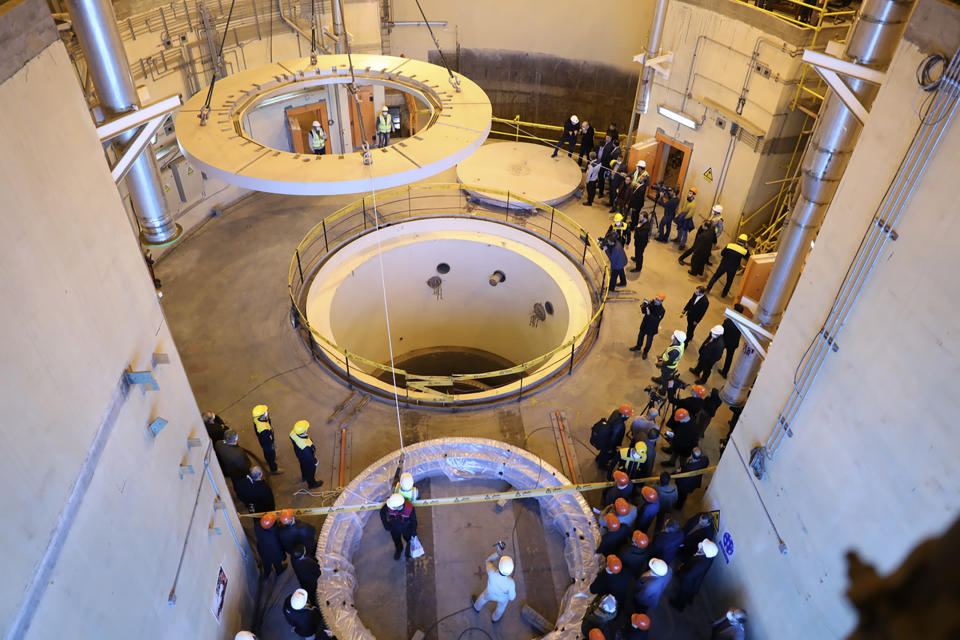 In this photo released by the Atomic Energy Organization of Iran, technicians work at the Arak heavy water reactor's secondary circuit, as officials and media visit the site, near Arak, 150 miles (250 kilometers) southwest of the capital Tehran, Iran, Monday, Dec. 23, 2019. The head of Iran’s nuclear agency says his country has begun new operations at the heavy water nuclear reactor. The move intensifies pressure on Europe to find an effective way around U.S. sanctions, which block Tehran’s oil sales abroad. (Atomic Energy Organization of Iran via AP)