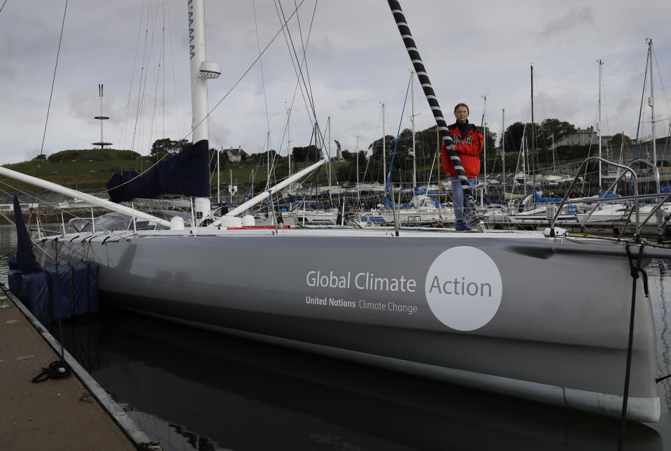 Greta Thunberg poses for a picture on the boat Malizia as it is moored in Plymouth, England Tuesday, Aug. 13, 2019. Greta Thunberg, the 16-year-old climate change activist who has inspired student protests around the world, is heading to the United States this week - in a sailboat. (AP Photo/Kirsty Wigglesworth)