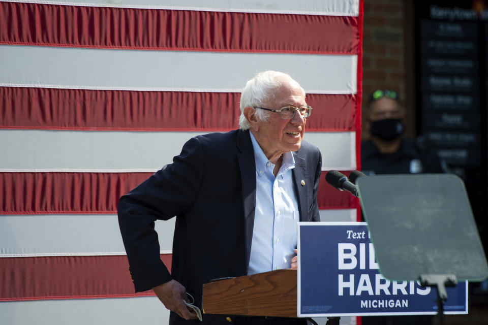 Vermont Sen. Bernie Sanders approaches the stage at Kerrytown Market in Ann Arbor on Monday, Oct. 5, 2020. Twenty-five people were permitted inside the socially-distanced rally, while a larger group gathered on the sidewalk outside. (Jacob Hamilton/Ann Arbor News via AP)