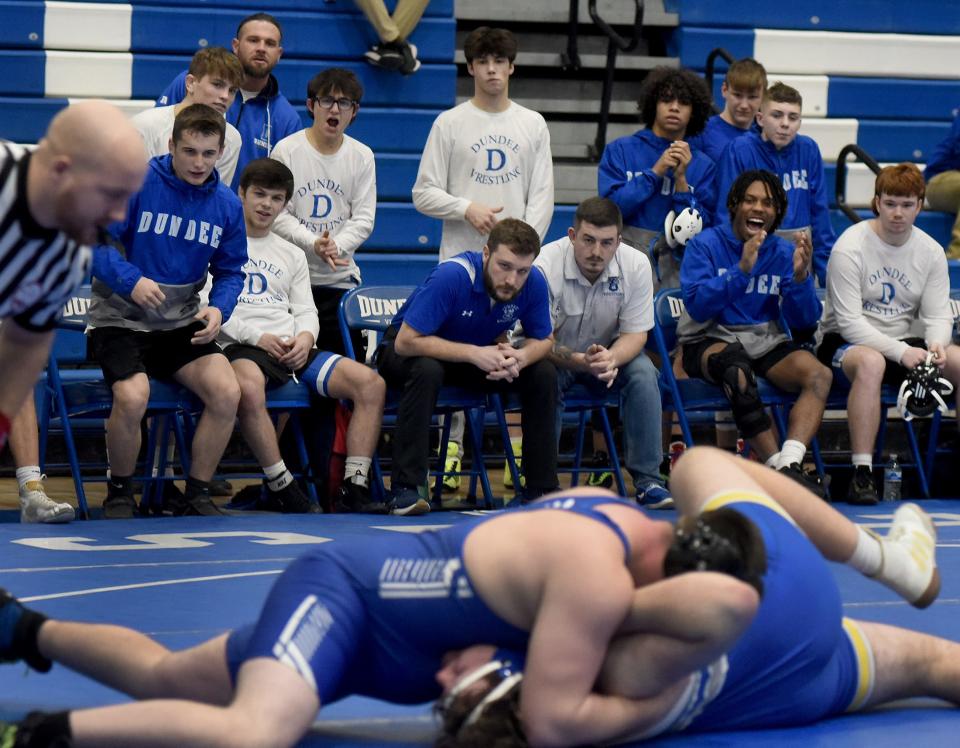 Dundee coaches Nate Hall and Garrett Stevens look on as they wait for the pin top be called in the 285 match between Aiden Massingill (top) and Jackson Wertenberger of Ida in the the Division 3 Team District semifinals on Feb. 7, 2024.