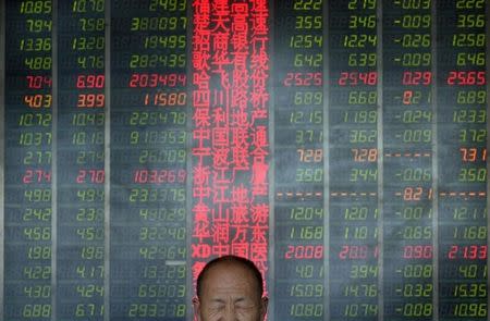 An investor reacts in front of an electronic board showing stock information at a brokerage house in Taiyuan, Shanxi province, May 9, 2013. REUTERS/Jon Woo