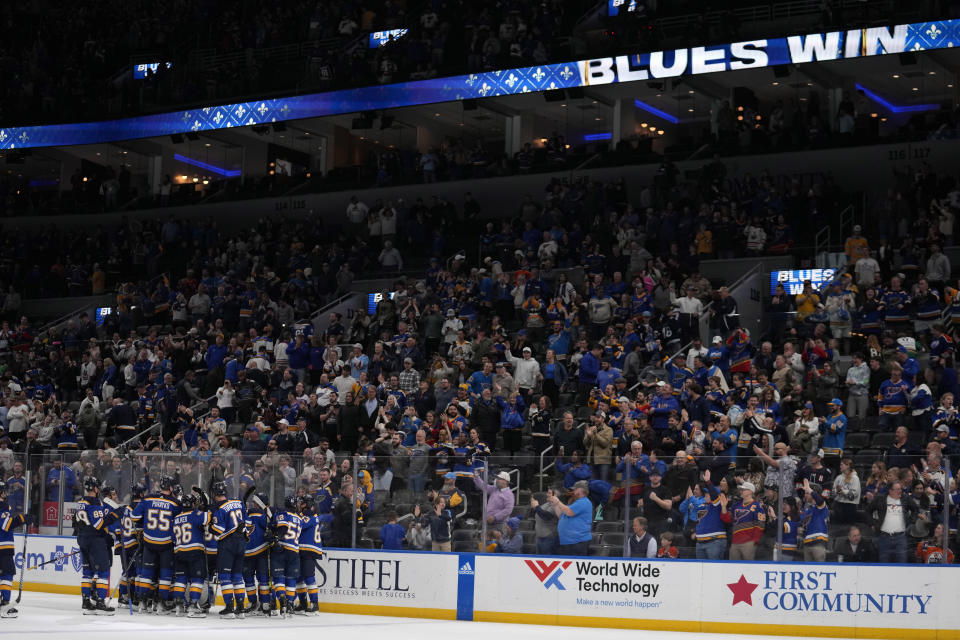 Members of the St. Louis Blues celebrate after defeating the Edmonton Oilers in overtime of an NHL hockey game Monday, April 1, 2024, in St. Louis. (AP Photo/Jeff Roberson)