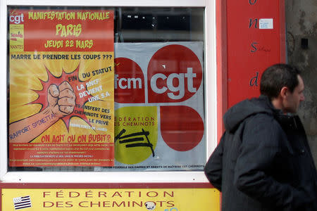 A man passes the premises of the union of the CGT railworkers (Cheminots), near a rail station in Nantes, France March 20, 2018. REUTERS/Stephane Mahe