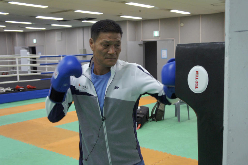 Former Olympic gold medalist Park Si-hun wearing boxing gloves punches a bag for photos after an interview on Jeju Island, South Korea, Tuesday, July 21, 2020. The last South Korean boxer to win an Olympic gold has spent the past 32 years wishing it was a silver. Park's 3-2 decision win over Roy Jones Jr. in the light-middleweight final at the 1988 Seoul Olympics remains one of the controversial moments in boxing history. Jones had seemed to dominate. (AP Photo/Kim Tong-hyung)