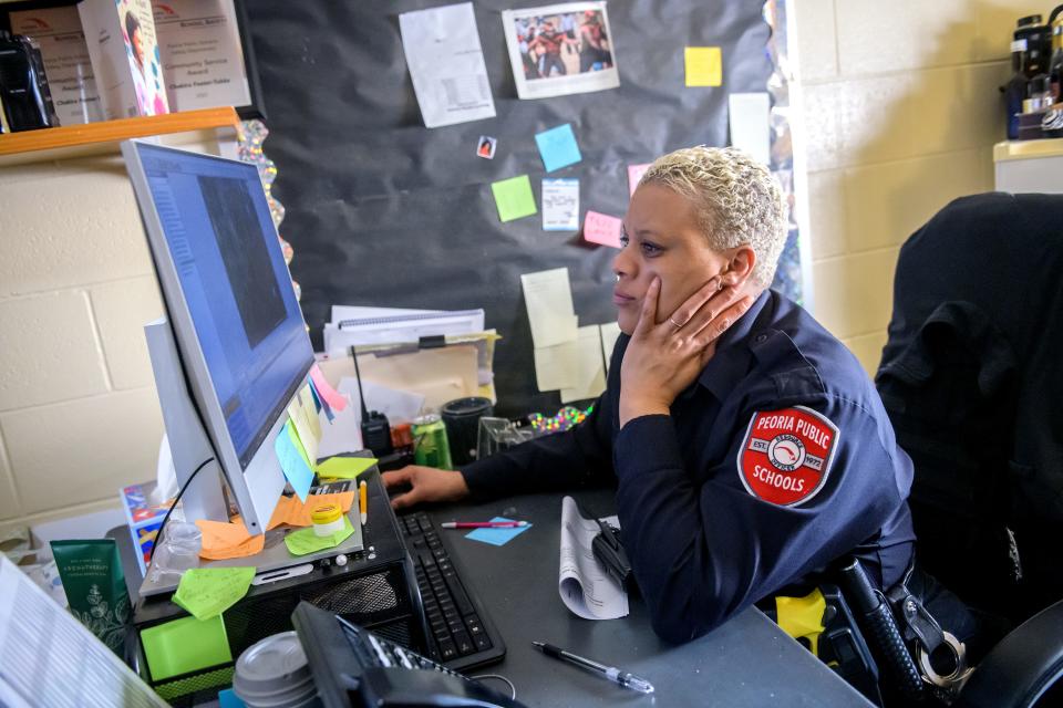 Manual High School resource officer Chakira Foster-Tubbs reviews video from the many cameras installed around the South Peoria school.