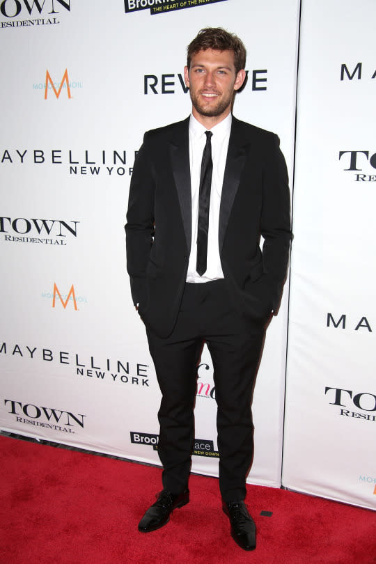 Alex Pettyfer in a classic black suit and skinny tie.