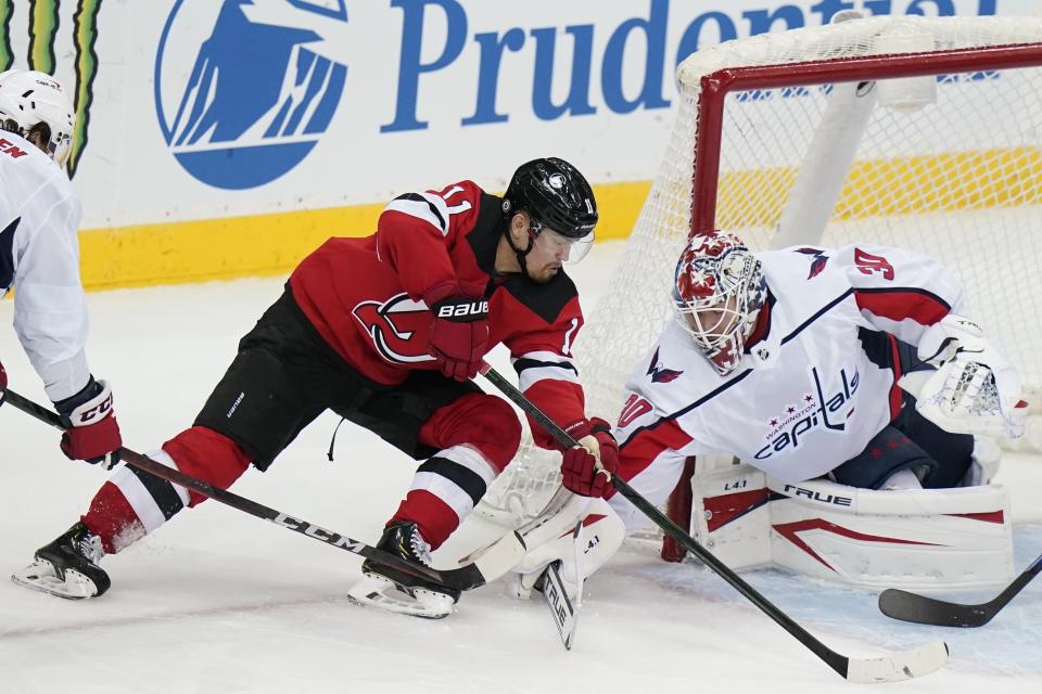 Washington Capitals goaltender Ilya Samsonov (30) stops a shot on goal by New Jersey Devils' Andreas Johnsson (11) during the first period of an NHL hockey game Sunday, April 4, 2021, in Newark, N.J. (AP Photo/Frank Franklin II)