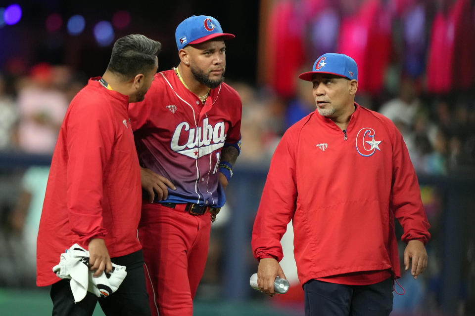 MIAMI, FLORIDA - MARCH 19: Yoan Moncada #10 of Team Cuba receives medical attention after colliding while trying to make a catch in the sixth inning against Team USA during the World Baseball Classic Semifinals at loanDepot park on March 19, 2023 in Miami, Florida. (Photo by Eric Espada/Getty Images)