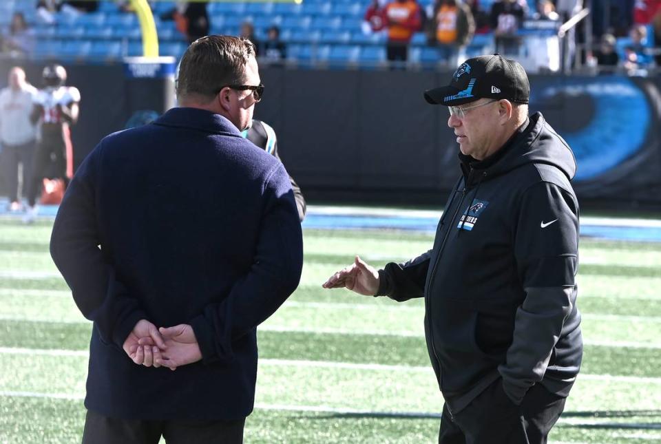 Carolina Panthers general manager Scott Fitterer, left, speaks with team owner David Tepper along the team’s sideline during pregame activities at Bank of America Stadium in Charlotte, NC on Sunday, January 7, 2024. The Tampa Bay Buccaneers defeated the Panthers 9-0. Tepper fired Fitterer after three seasons as GM on Monday, January 8, 2024.