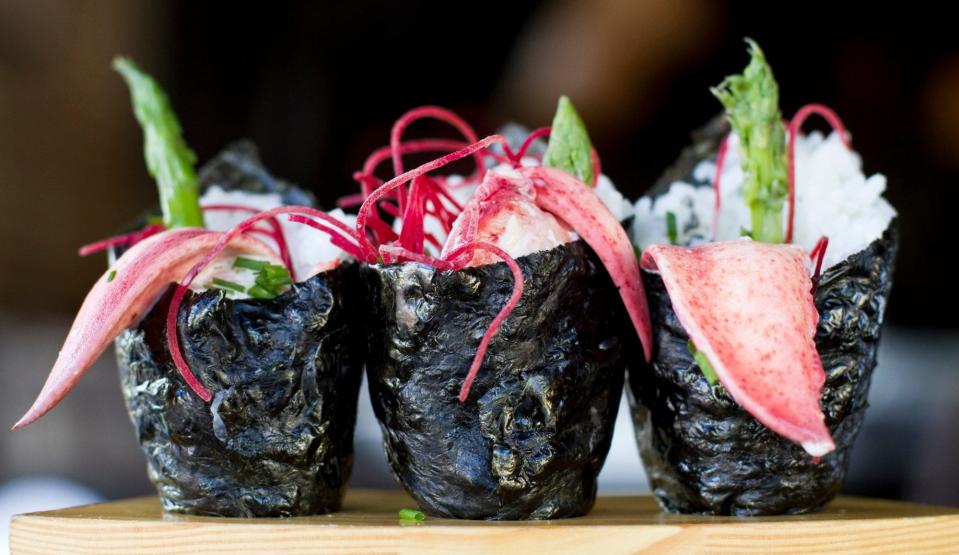 O-Ku's Lobster Temaki: Butter-poached lobster hand rolls with asparagus, chives, cilantro aioli, beets, black volcanic salt.