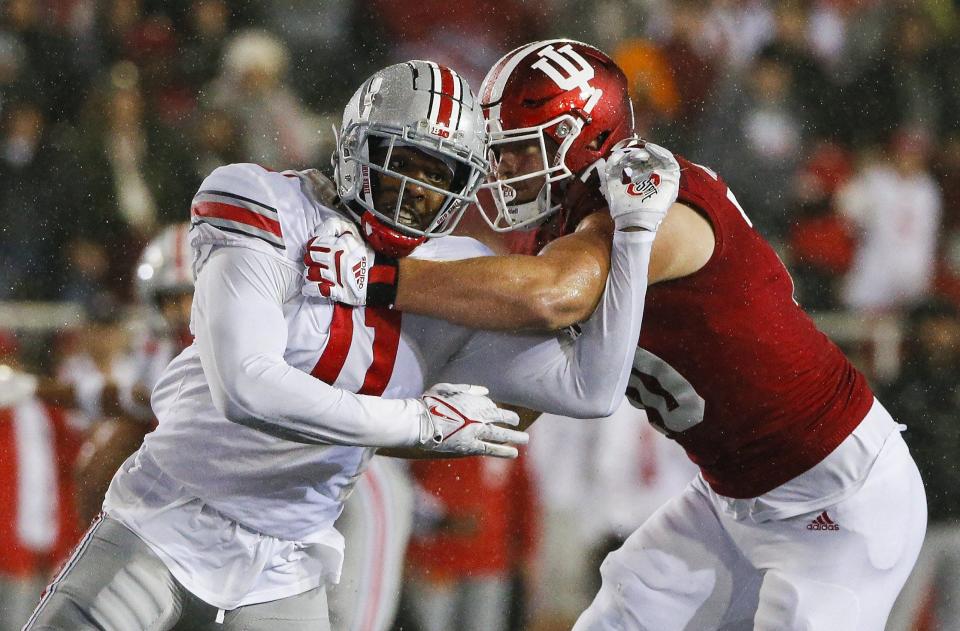 Ohio State Buckeyes defensive end Tyreke Smith (11) moves past Indiana Hoosiers offensive lineman Luke Haggard (70) during the second quarter of a NCAA Division I football game between the Indiana Hoosiers and the Ohio State Buckeyes on Saturday, Oct. 23, 2021 at Memorial Stadium in Bloomington, Ind.