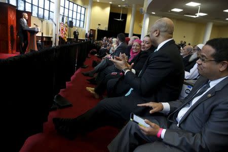 U.S. Representative Keith Ellison (D-MN) (R) applauds with other members of the audience as U.S. President Barack Obama (L) delivers remarks at the Islamic Society of Baltimore mosque in Catonsville, Maryland February 3, 2016. REUTERS/Jonathan Ernst